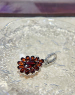 Detail view of Fancy halo garnet necklace silver featuring Red Garnet