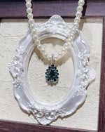 Close-up of Fancy halo topaz necklace sterling silver featuring London Blue Topaz