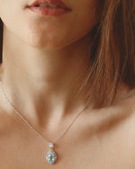 On-model view of Aquamarine Halo Necklace Silver, ideal Anniversary or Mother's Day gift