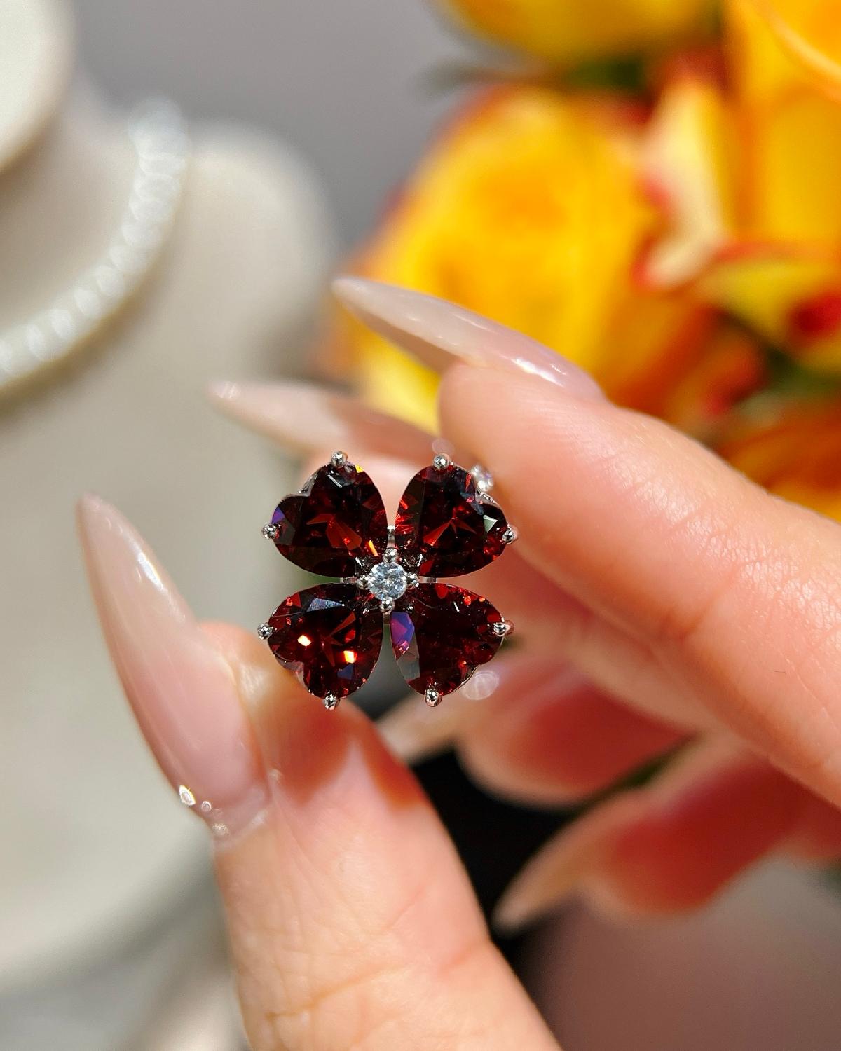 Lifestyle photography of Heart cut garnet clover ring featuring Heart Cut center stone