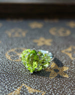 Lifestyle photography of Marquise cut peridot ring leaf design featuring Marquise Cut center stone