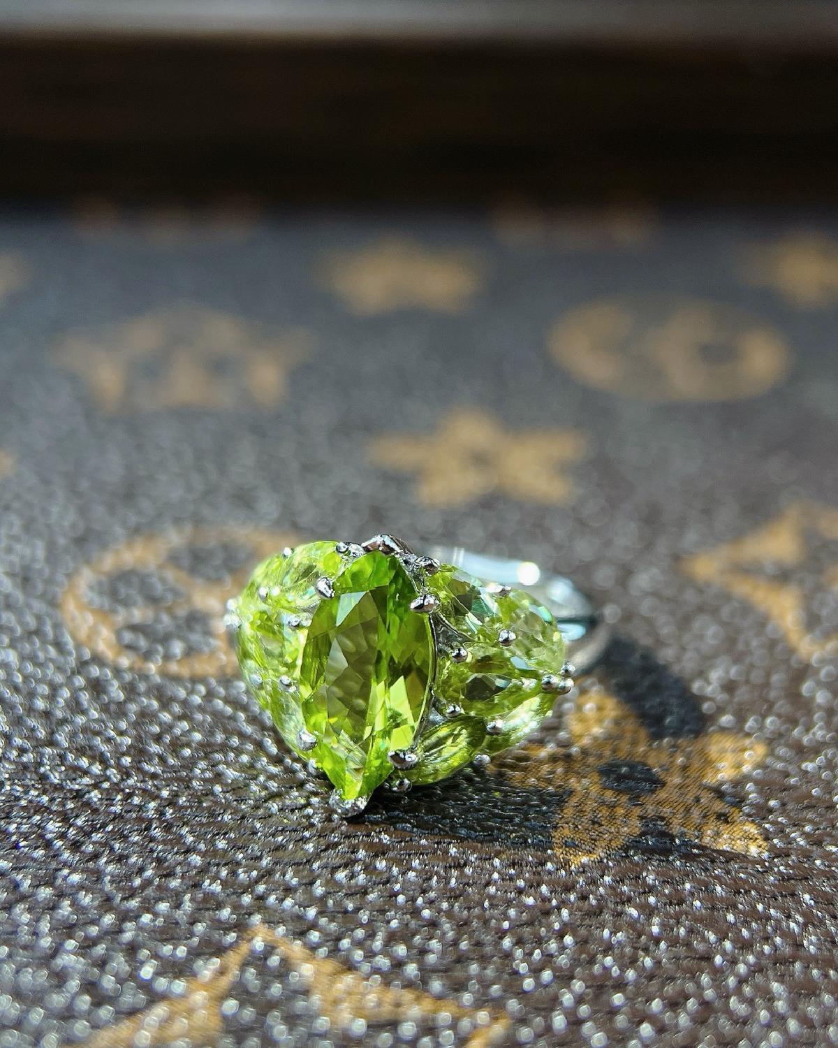 Lifestyle photography of Marquise cut peridot ring leaf design featuring Marquise Cut center stone