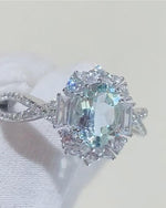 Lifestyle photography of Oval Aquamarine Halo Ring featuring Oval Cut center stone