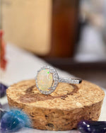 Lifestyle photography of Oval Cabochon Opal Halo Ring featuring Oval Cabochon center stone