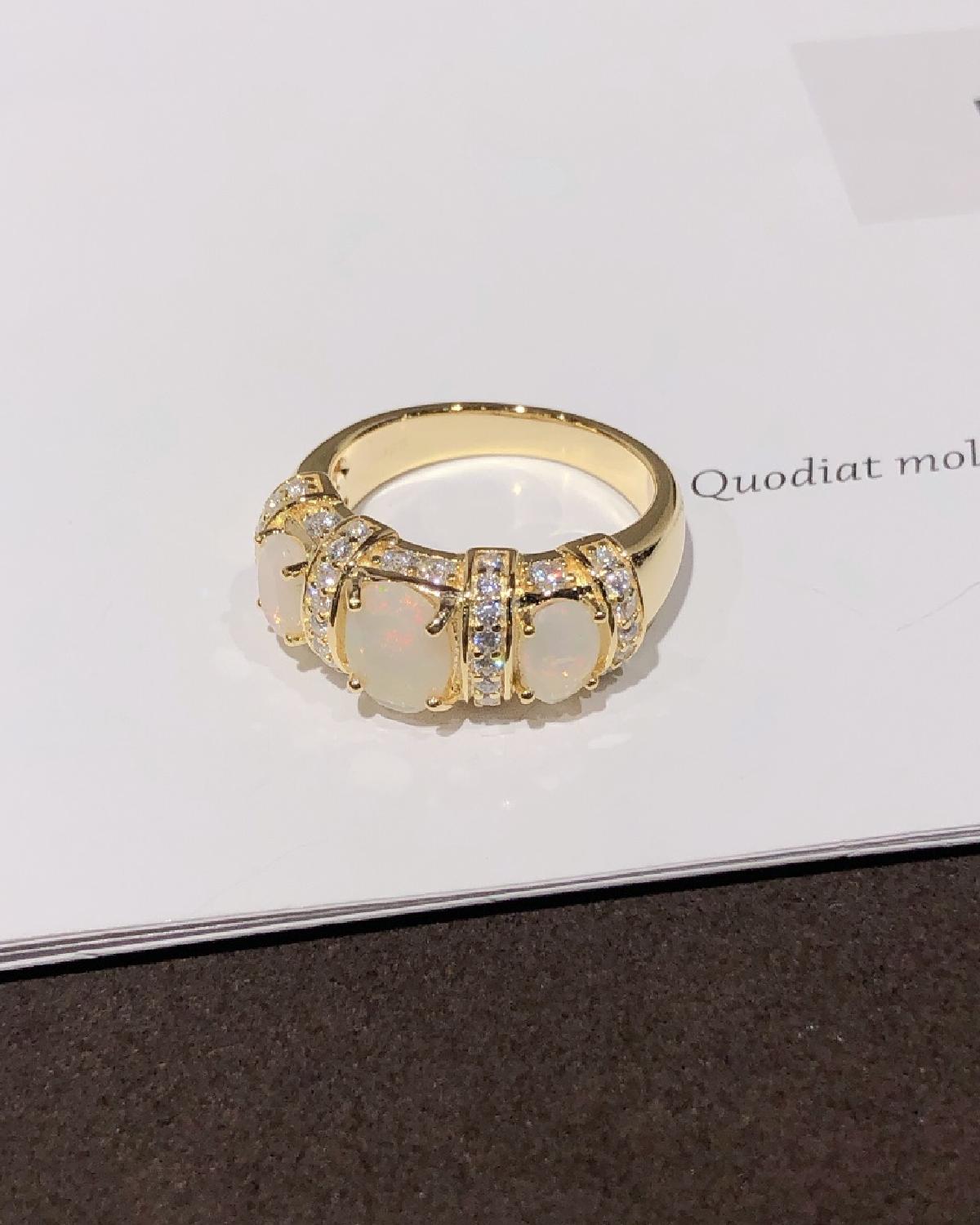 Lifestyle photography of Oval cabochon opal ring gold plated featuring Oval Cabochon center stone