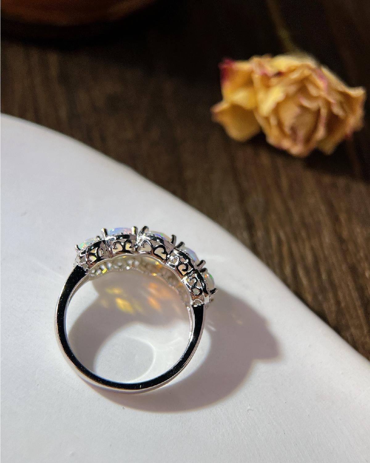 Lifestyle photography of Oval cut opal halo ring featuring Oval Cut center stone