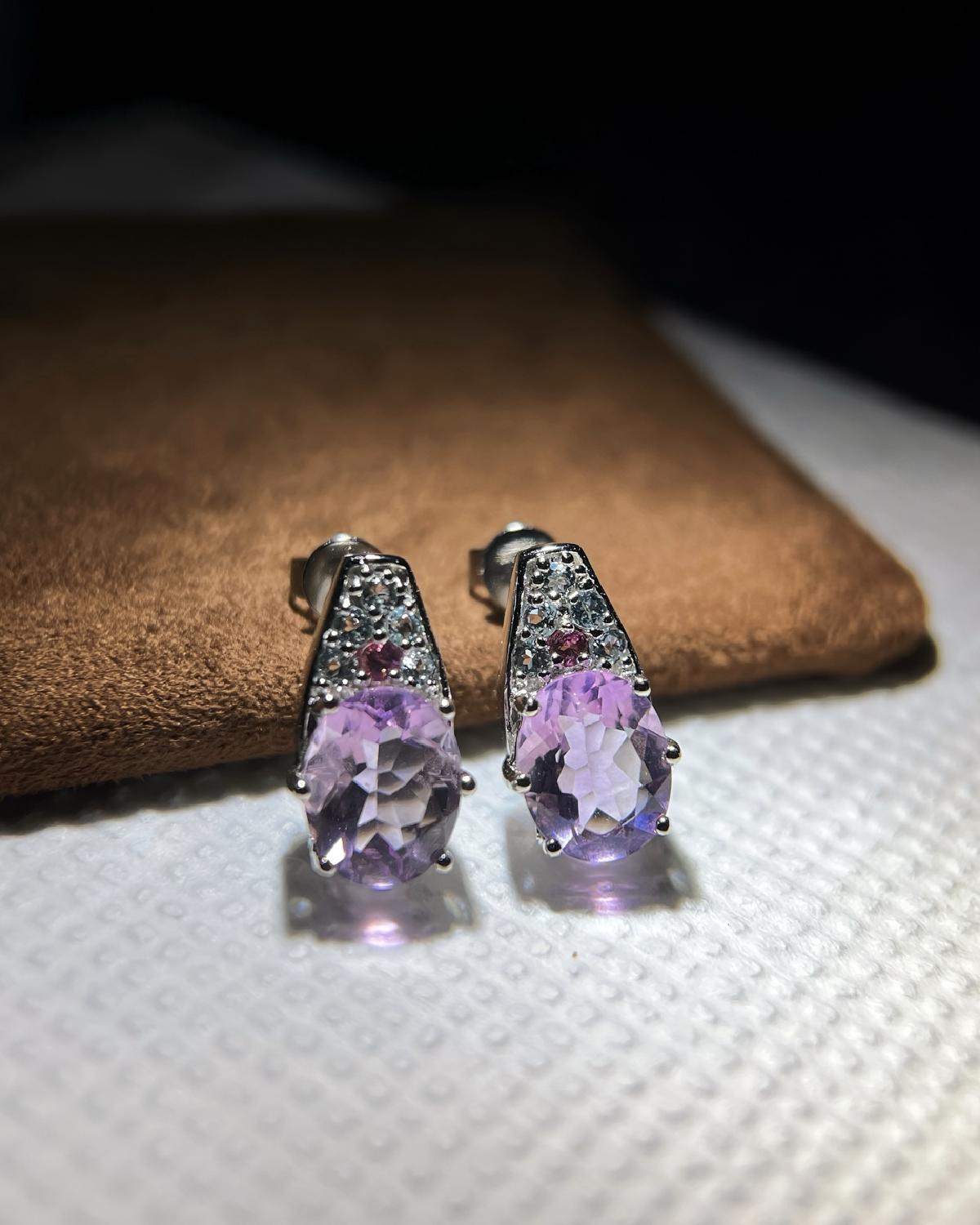 Lifestyle photography of Oval cut purple fluorite drop earrings featuring Oval Cut center stone