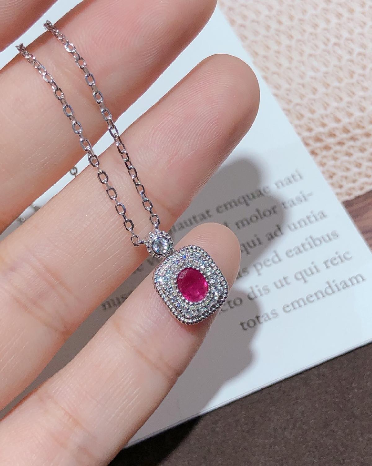 Lifestyle photography of Oval cut ruby halo necklace featuring Oval Cut center stone