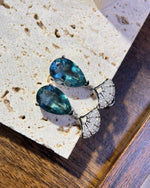Lifestyle photography of Pear cut blue fluorite dangle earrings featuring Pear Cut center stone