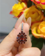 Real-life look at Pear cut garnet floral pendant featuring Pear Cut center stone