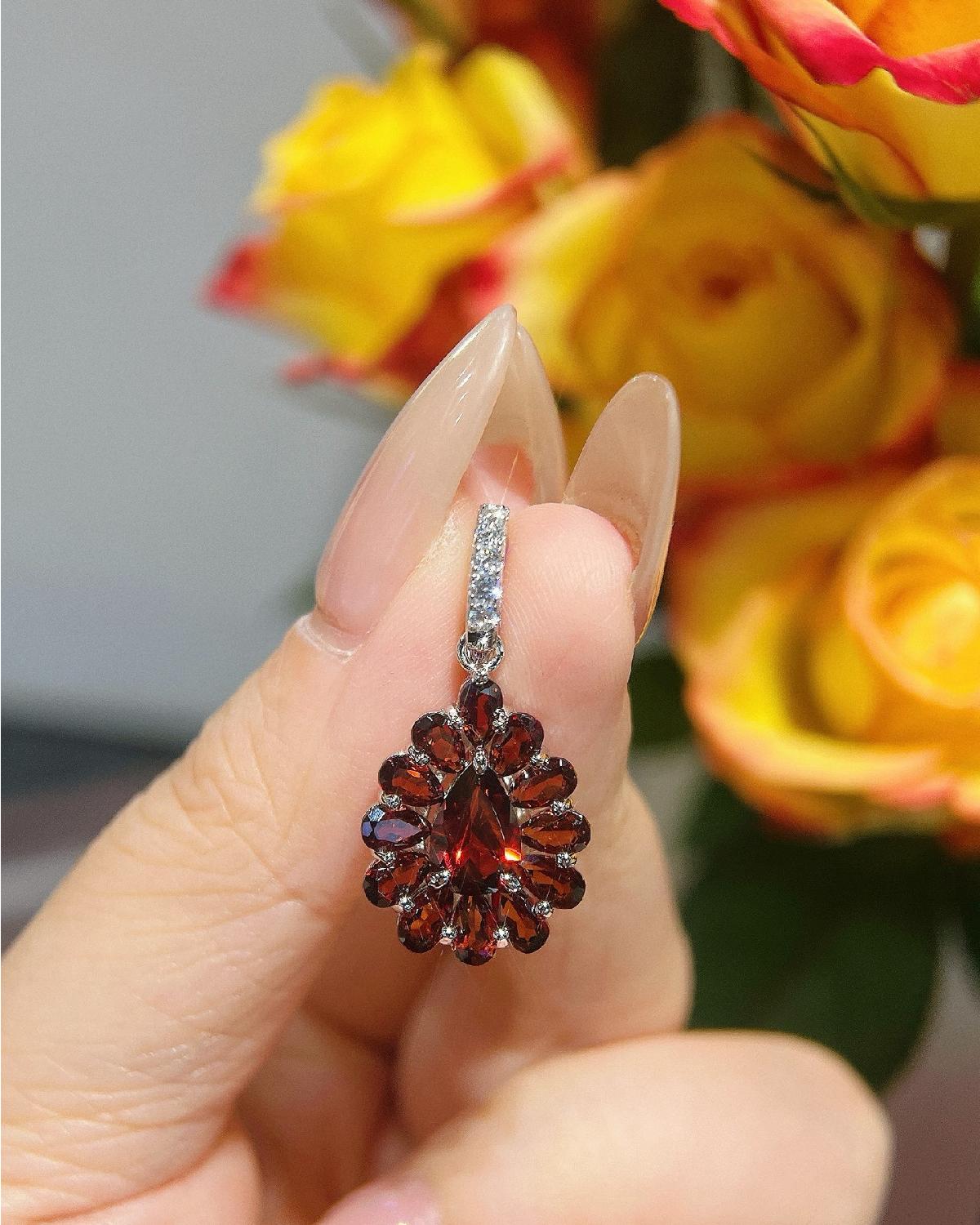 Real-life look at Pear cut garnet floral pendant featuring Pear Cut center stone