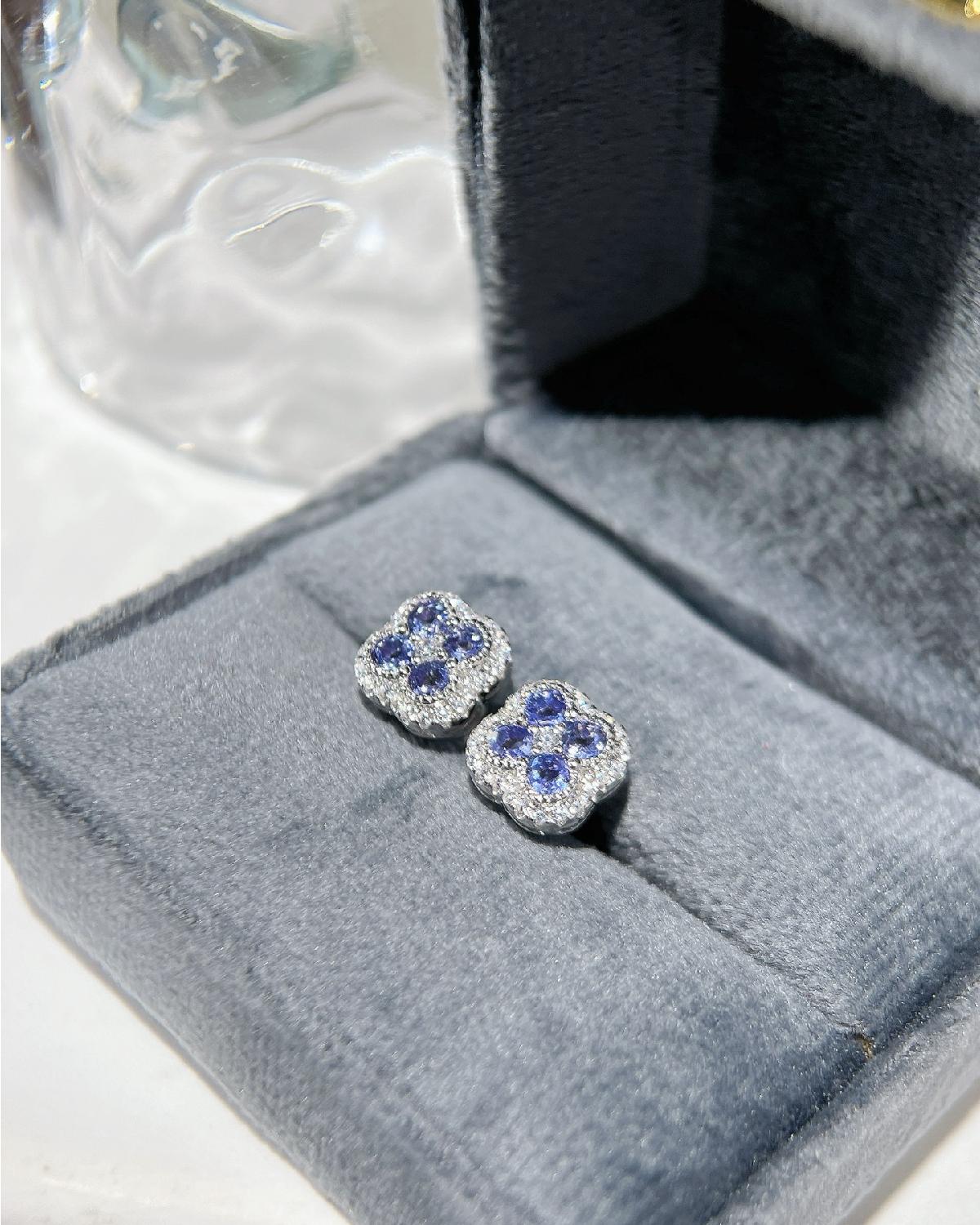 Lifestyle photography of Round tanzanite clover halo earrings featuring Round Cut center stone